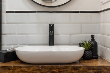 Modern Bathroom Sink with Black Faucet and Decor