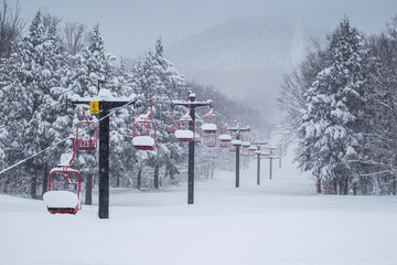 Ski mountain chairlift winter deep snow powder with snowy trees on a mountainside