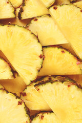 Pineapple juicy yellow slices background. Top view.