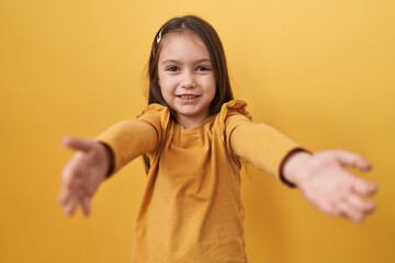 Adorable hispanic girl standing, arms wide open for huge hug! looking at camera with all the love...