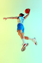 Low angle photo of athletic female basketball player leaping to make perfect shot in neon light against gradient studio background. Concept of sport, championship, tournament, hobby and recreation. Ad © Lustre Art Group 