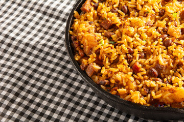 Baião de Dois traditional Brazilian food with rice, beans, sausage and rennet cheese close up