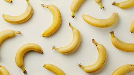 A collection of ripe fresh yellow bananas with a white background.