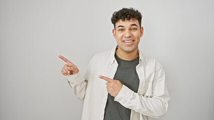 Young adult arab man with a beard, pointing fingers isolated on white background, embodying a...