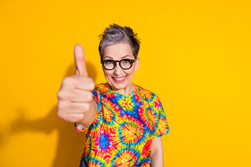Photo of positive nice lovely senior woman wear stylish print clothes thumb up isolated on bright...