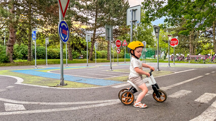 A child learns the rules of the road on his bike - a training park for children