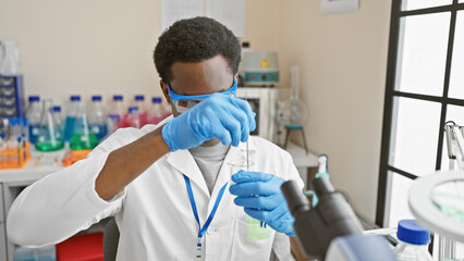 African man scientist working diligently with a test tube in a modern laboratory