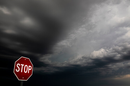 Dark storm clouds over a stop sign, Badlands National Park, South Dakota, USA. June, 2022. 