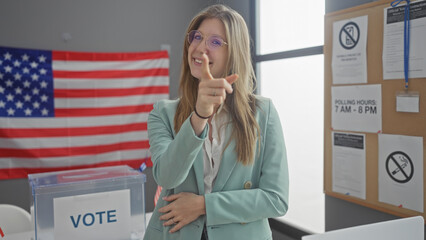 A young woman pointing and smiling in an american electoral college room with a flag and voting...