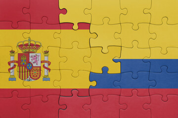 puzzle with the colourful national flag of colombia and flag of spain.