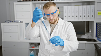 A young man conducting an experiment in a laboratory setting, focused on a test tube.