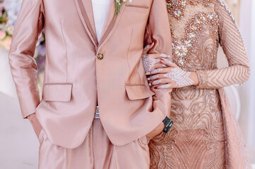 The bride's hand in a henna holding the groom's hand is so romantic with the same modern dress