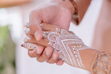 The bride's hand holding the groom's hand is so romantic