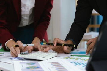 Close up of a team of business people having a meeting to analyze data for a marketing plan.	