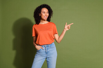 Photo portrait of lovely young lady look point empty space dressed stylish orange garment isolated on khaki color background