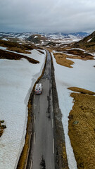 Campervan or motorhome travel camper van, Caravan trailer, or camper RV at the Lyse road covered with snow to Krejag Norway Lysebotn, a road covered with snow in the mountains