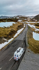 camper van, Caravan trailer, or camper RV at the Lyse road covered with snow to Krejag Norway Lysebotn, road covered with snow, drone aerial view