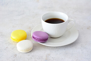 a plate of colorful macaroni with a cup of coffee  