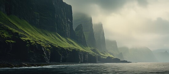 The towering sea cliffs provide a dramatic backdrop for the serene landscape in the copy space image.