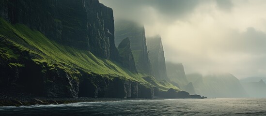 The towering sea cliffs provide a dramatic backdrop for the serene landscape in the copy space...