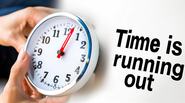 Hand holding a clock with the text “Time is running out” on a white background. Suitable for urgency, deadlines, and time management themes.
