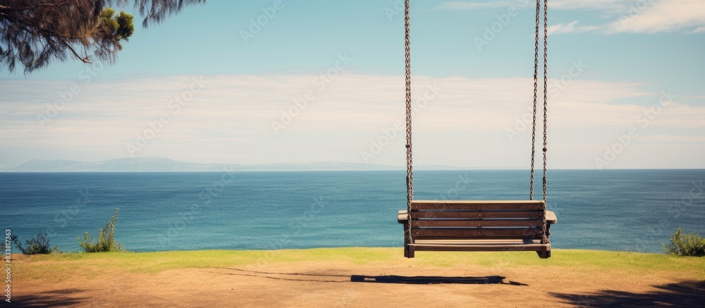 Aufkleber Swing with a view of the ocean in the background, perfect for a photo with copy space image.