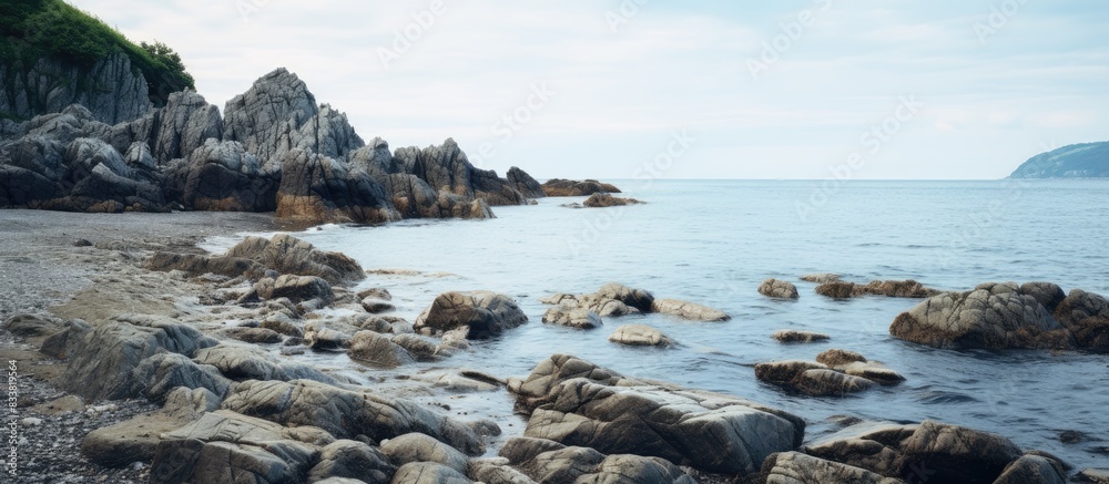 Poster Beautiful coastal rocks by the beach with a captivating view and copy space image.