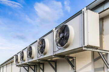 Row of Air conditioner compressors installed on a wall of industrial building