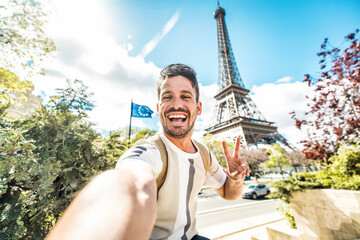 Happy tourist taking selfie picture in front of Eiffel Tower in Paris, France - Travel and summer...