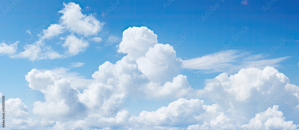 Aufkleber white clouds fill the sky with a backdrop of blue, creating a peaceful and serene atmosphere for any