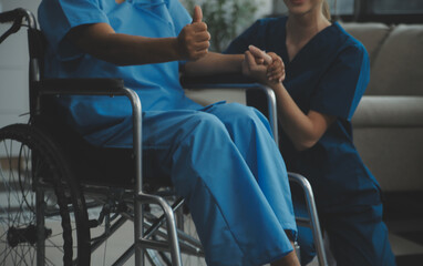Obraz premium Doctor giving hope. Close up shot of young female physician leaning forward to smiling elderly lady patient holding her hand in palms. Woman caretaker in white coat supporting encouraging old person
