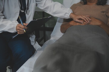 Cropped shot of a female nurse hold her senior patient's hand. Giving Support. Doctor helping old...