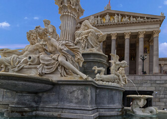 Fototapeta premium Intricate sculptures and fountain in front of the parliament building, Vienna, Austria