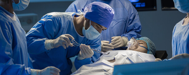 Surgeons team working with Monitoring of patient in surgical operating room. The doctors and nurses...