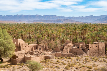 Old ancient ruins of village houses near Agdz town in desert landscape of Atlas Mountains, Morocco,...