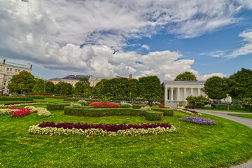 Colorful flowers contrast the carefully cut greens, Vienna, Austria