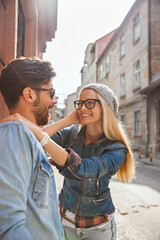 Happy couple enjoying a playful moment outdoors on city street