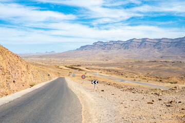 Road in desert landscape of Atlas Mountains near Tamnougalt village, Morocco, North Africa