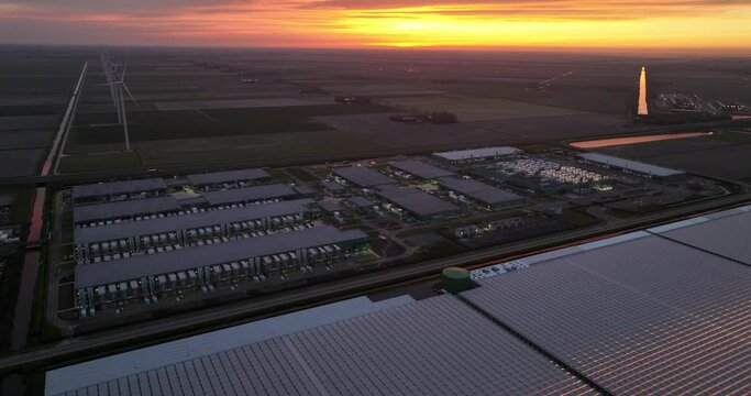Drone footage of datacenter building facility and business infrastructure at dusk in the Netherlands