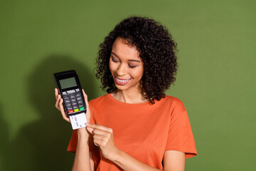 Photo portrait of lovely young lady pay credit card terminal dressed stylish orange garment...