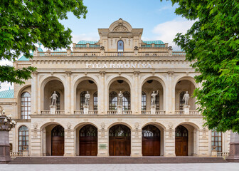 Ganja State Philharmonic Hall in Ganja, Azerbaijan. The building features a classical facade with arches, columns, and statues, and known for its beautiful architecture and its cultural performances