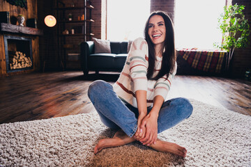 Photo of pretty excited lady dressed striped pullover sitting floor laughing having fun indoors house room
