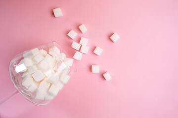 Glass full of sugar cubes. Unhealthy diet concept. Minimal, copy space, side view
