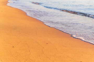 Soft wave of the sea on the sandy beach.
