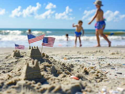 A beach scene with a sandcastle decorated with small American flags and children playing in the background, with the horizon providing a clear area for text placement.