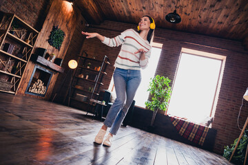 Full size photo of lovely young woman dancing listen music headphones wear striped outfit interior...