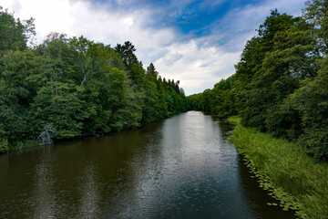 Scenic view of a river against cloudy sky