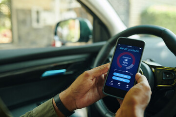 Driver checking charging level via mobile app