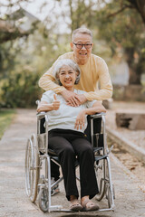 Elderly couple husband and wife happy asian people giving love and care Wheelchair in the park relaxing in spring, relaxing and walking outside at the park.