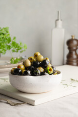 Mix of green and black olives, in a bowl